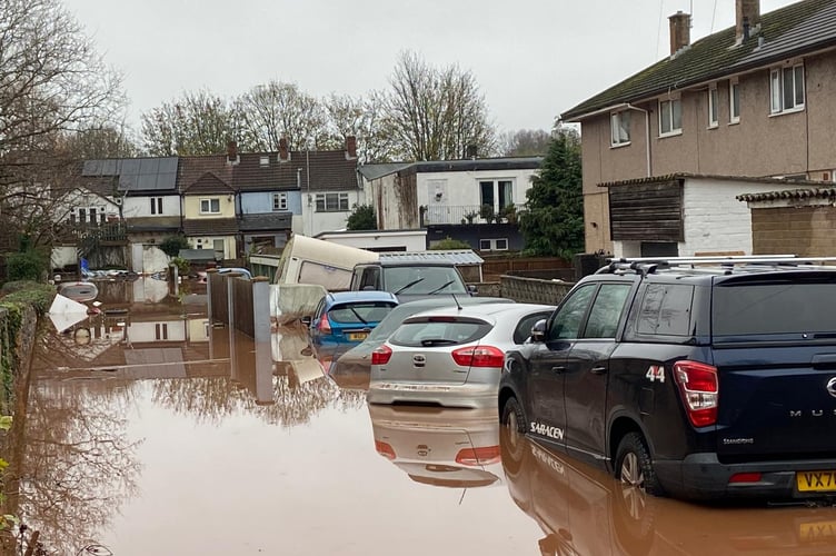 Flood waters swamp parked cars all over town