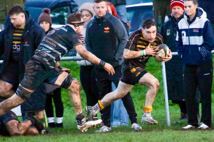 A Newent player escapes down the wing