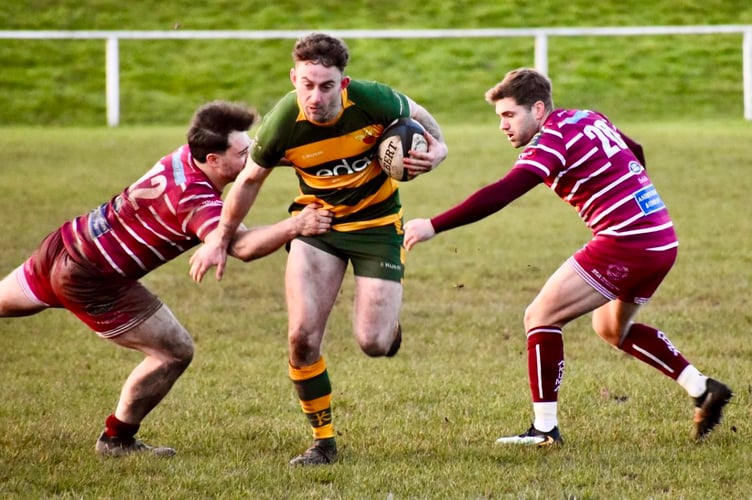 A Newent player tries to find a way through against Newport Salop