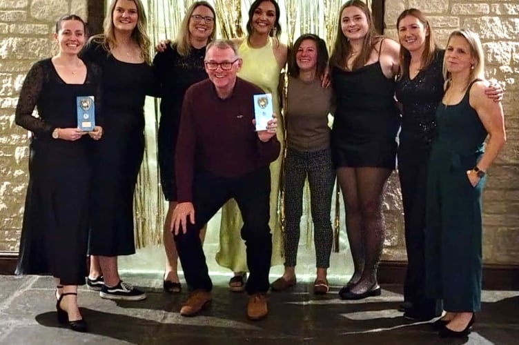 Aston Ingham CC's women celebrate their victory with coach Dave Skyrme
