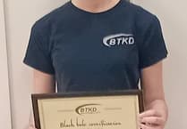 Teen Katie kicks on with black belt second dan