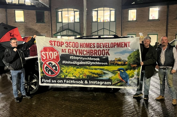 Residents pictured outside the Forest Council offices holding a banner opposing development at Glynchbrook.