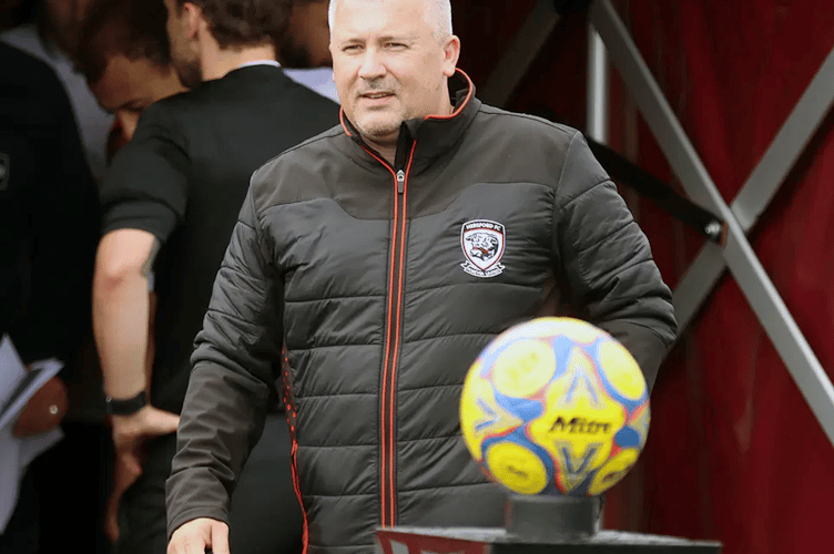 Relegation-threatened Hereford FC are managerless after parting company with ex-Scotland player Paul Caddis