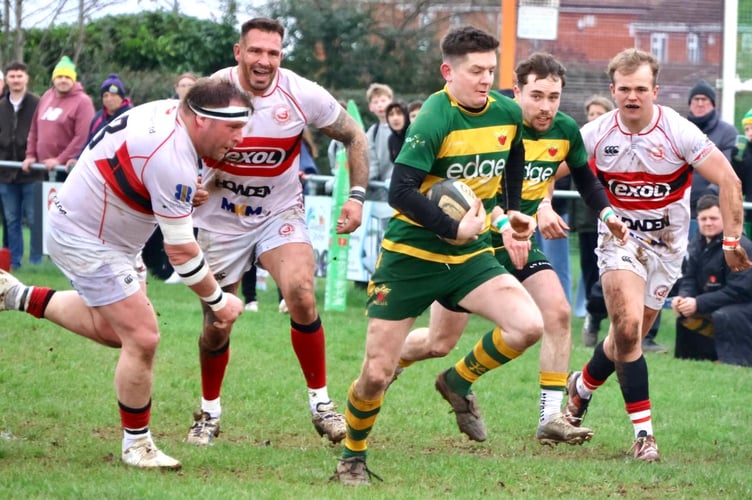 A Newent player breaks through to score another try