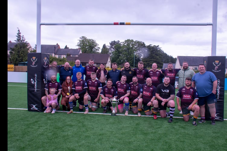The Brody's Trust team with the trophy.