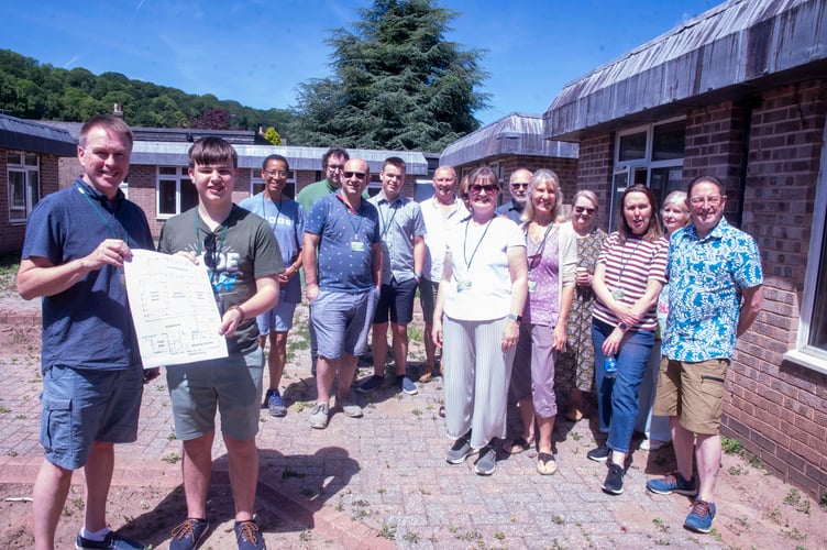 Steve Jones and Jack Evans wiith a copy of the plans along with other members of the church.