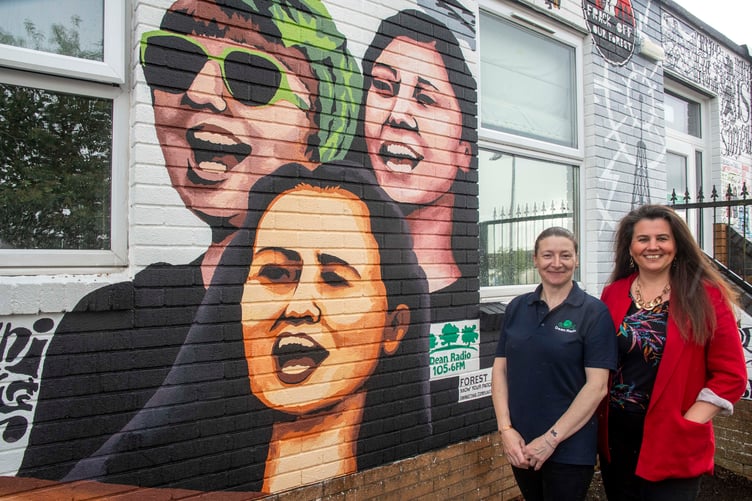 Dean Radio presenter Kirsty Vittorini and Jessica Shackell of Coleford Community Choir feaature on the mural