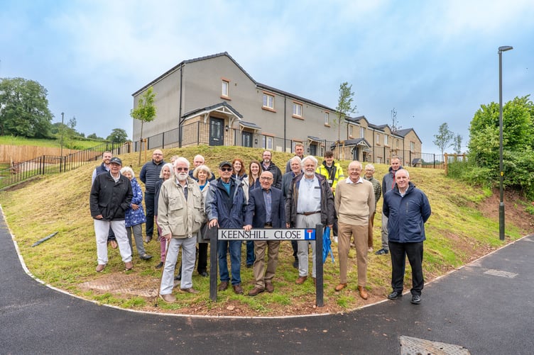Project partners celebrate the completion of the houses.