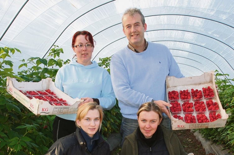 Neil Cockburn and colleagues at the fruit farm (image supplied)