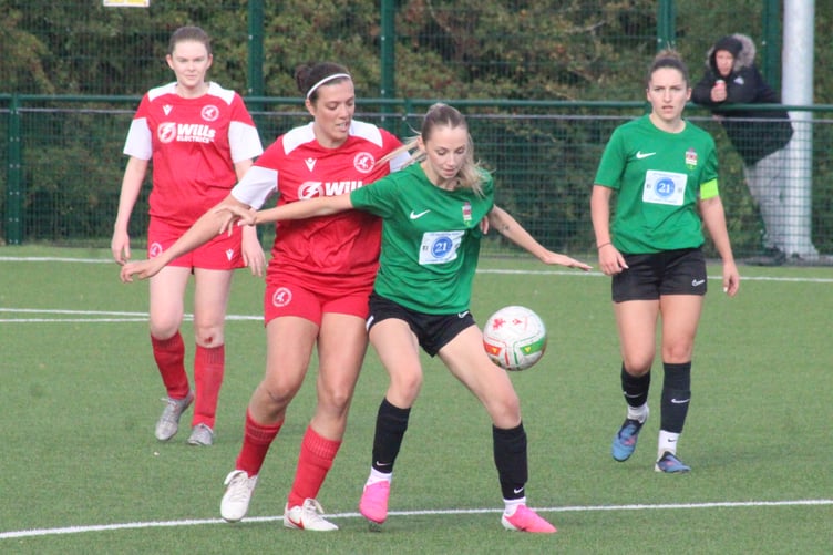 A Juniors player battles for the ball