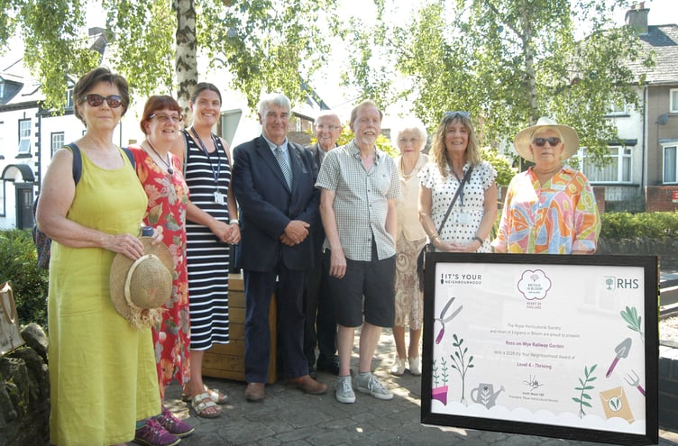 Ross-in-Bloom volunteers at the revitalised Railway Garden with Royal Horticultural Society’s judge Janet Gwinnett pictured extreme right and insert the Thriving certificate