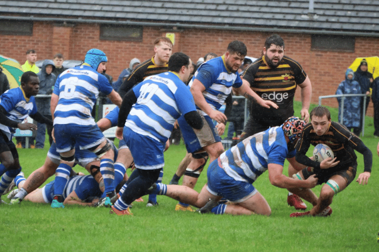 A Newent player is tackled by the Ross cover